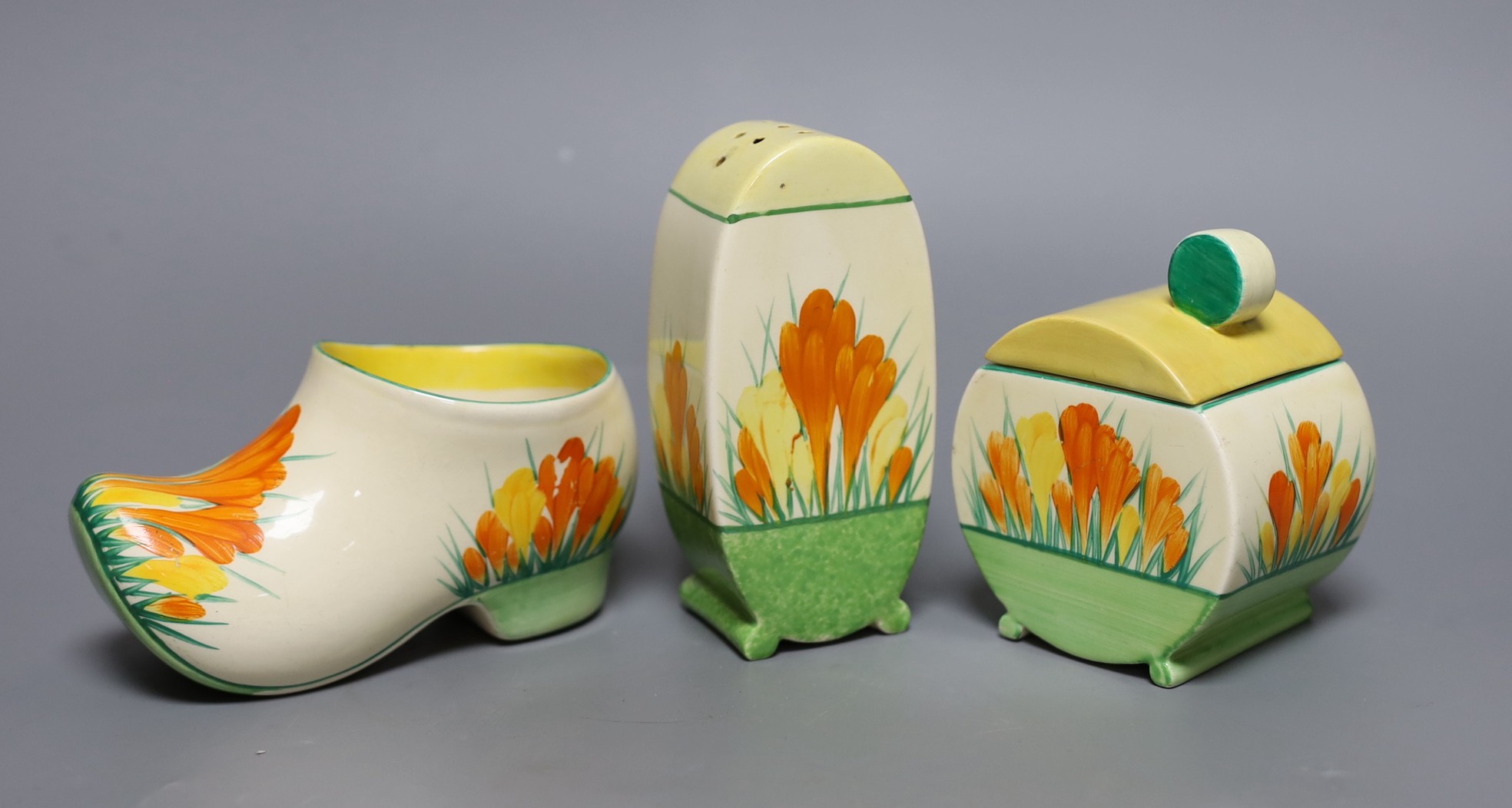 A Clarice Cliff sungleam crocus jam pot and cover, a sugar shaker and a Dutch clog ornament (3), jam pot and cover 10 cms high